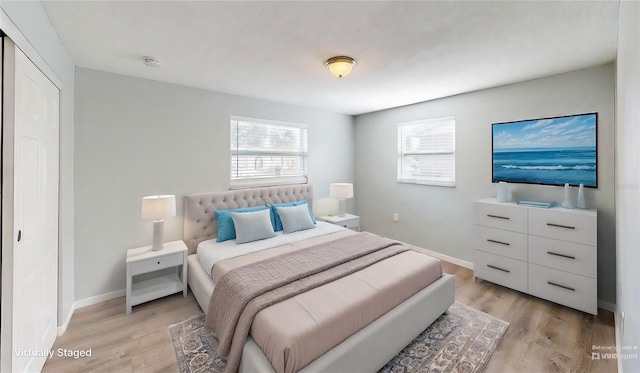 bedroom with baseboards and light wood-type flooring
