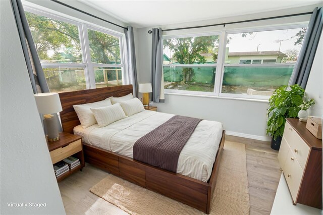 bedroom with baseboards and light wood-style floors