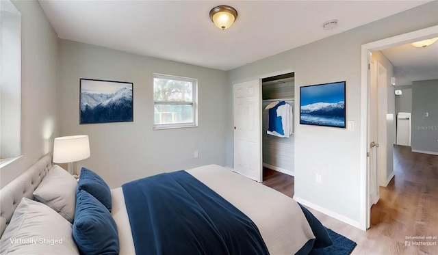 bedroom featuring a closet, baseboards, and wood finished floors