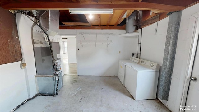 unfinished below grade area with washing machine and clothes dryer