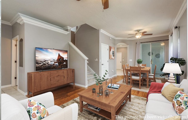9106 Crystal Commons Way, Tampa, FL 33626 - living area featuring a ceiling fan, arched walkways, stairway, wood finished floors, and ornamental molding