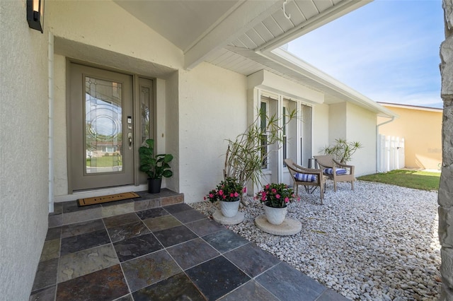 7906 Bayshore Dr, Seminole, FL 33776 - view of exterior entry featuring stucco siding