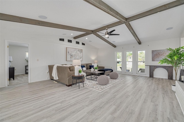 7906 Bayshore Dr, Seminole, FL 33776 - living room featuring light wood finished floors, visible vents, vaulted ceiling with beams, and ceiling fan