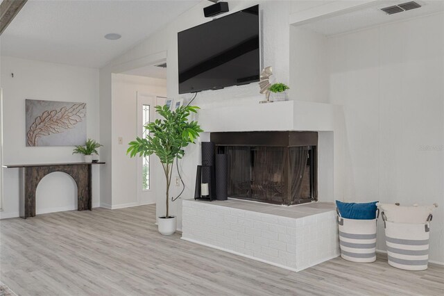 7906 Bayshore Dr, Seminole, FL 33776 - details with visible vents, wood finished floors, and a brick fireplace