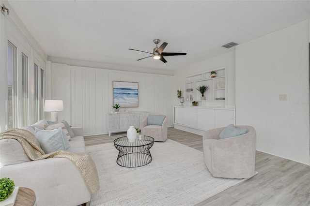 7906 Bayshore Dr, Seminole, FL 33776 - living area featuring visible vents, light wood-style flooring, and a ceiling fan