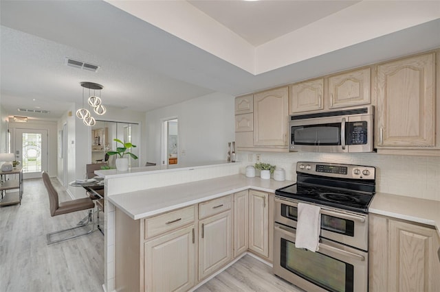 7906 Bayshore Dr, Seminole, FL 33776 - kitchen with visible vents, light countertops, backsplash, and stainless steel appliances
