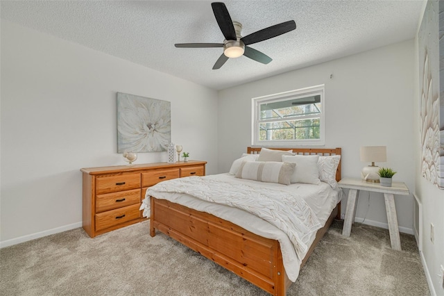 7906 Bayshore Dr, Seminole, FL 33776 - bedroom featuring light carpet, baseboards, a ceiling fan, and a textured ceiling