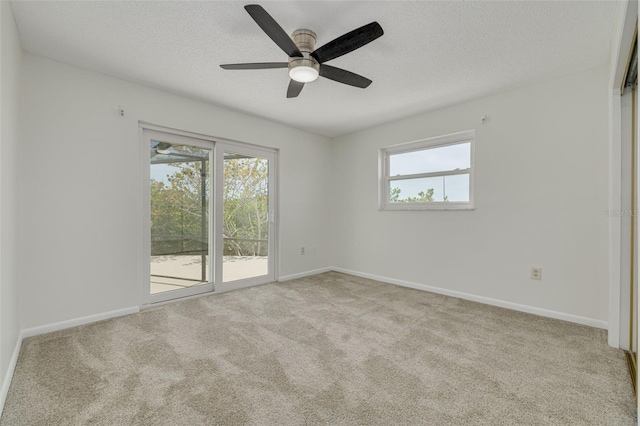 7906 Bayshore Dr, Seminole, FL 33776 - carpeted empty room with a textured ceiling, baseboards, and ceiling fan