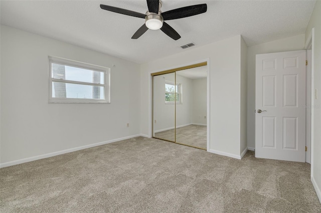 7906 Bayshore Dr, Seminole, FL 33776 - unfurnished bedroom with a closet, baseboards, a textured ceiling, carpet floors, and visible vents