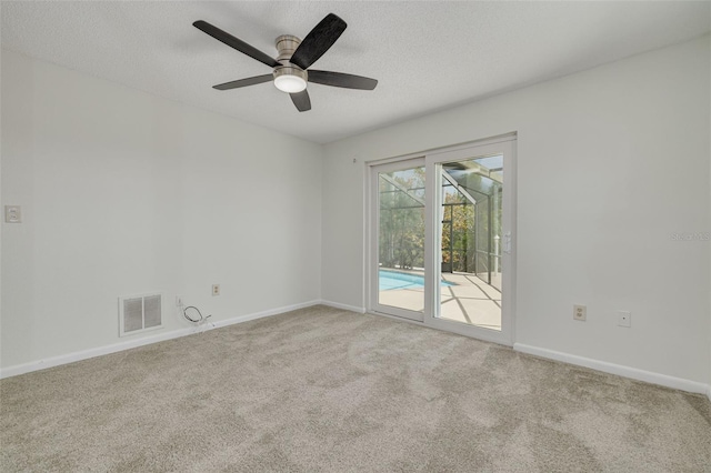 7906 Bayshore Dr, Seminole, FL 33776 - carpeted empty room featuring visible vents, ceiling fan, baseboards, and a textured ceiling