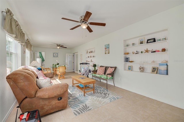 2605 Fulton St SW, Largo, FL 33774 - living room featuring a ceiling fan, tile patterned flooring, built in shelves, and baseboards