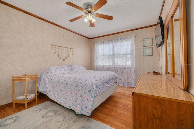 2605 Fulton St SW, Largo, FL 33774 - bedroom featuring wood finished floors, crown molding, a textured ceiling, and a ceiling fan