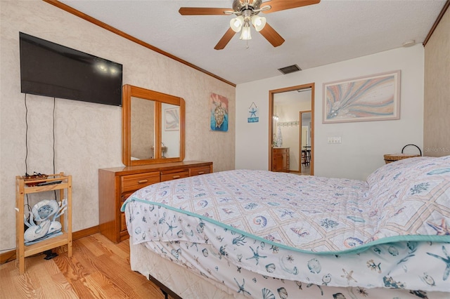 2605 Fulton St SW, Largo, FL 33774 - bedroom with light wood-type flooring, ornamental molding, a textured ceiling, and a ceiling fan