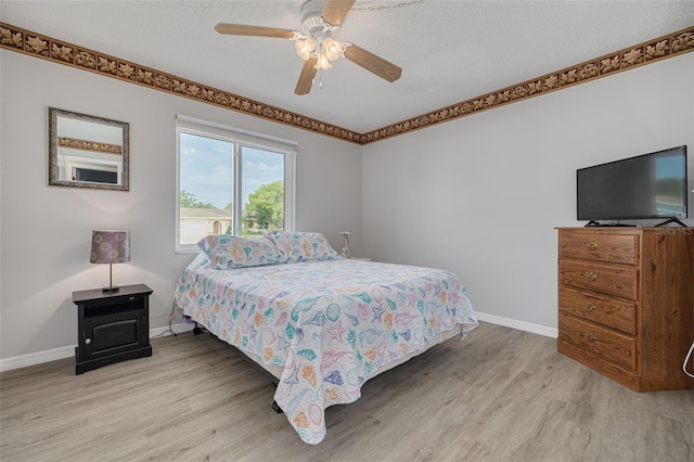 2605 Fulton St SW, Largo, FL 33774 - bedroom with light wood-type flooring, baseboards, and a ceiling fan