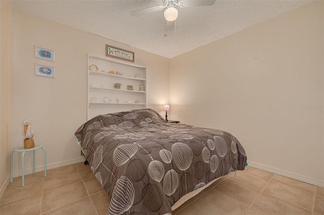 2605 Fulton St SW, Largo, FL 33774 - tiled bedroom with a textured ceiling, ceiling fan, and baseboards