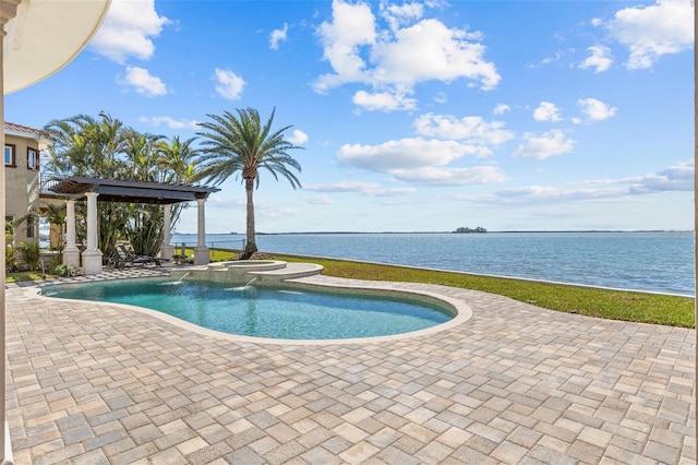 view of swimming pool featuring a pool with connected hot tub, a water view, and a patio area