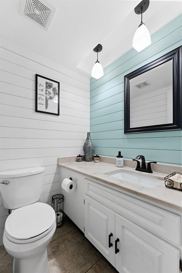 170 Ingrid Pl, Oldsmar, FL 34677 - half bath with wooden walls, toilet, vanity, and visible vents