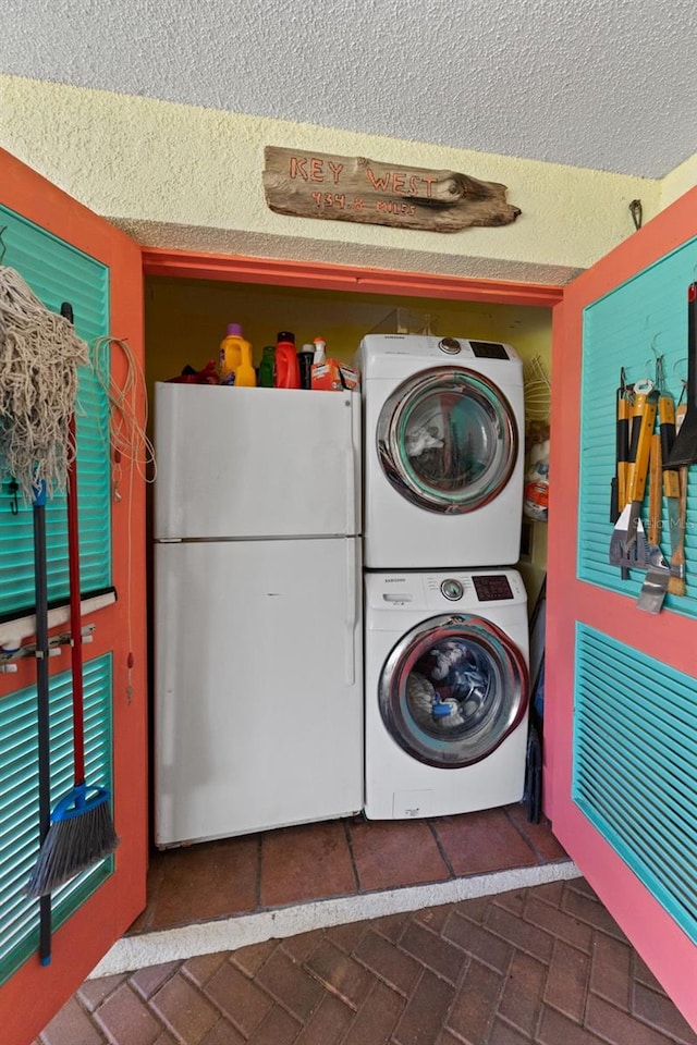 170 Ingrid Pl, Oldsmar, FL 34677 - washroom with brick floor, a textured ceiling, and stacked washer / dryer
