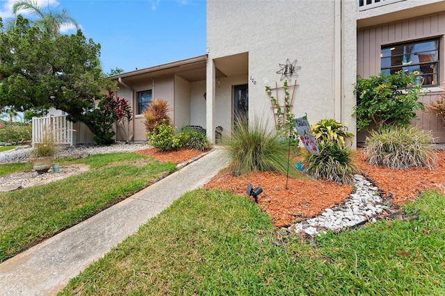 170 Ingrid Pl, Oldsmar, FL 34677 - doorway to property featuring a lawn, stucco siding, and fence