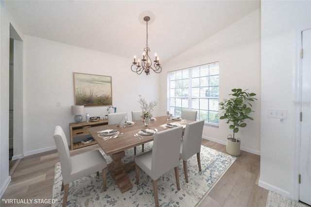 5331 Villagebrook Dr, Wesley Chapel, FL 33544 - dining area featuring a chandelier, light wood finished floors, vaulted ceiling, and baseboards