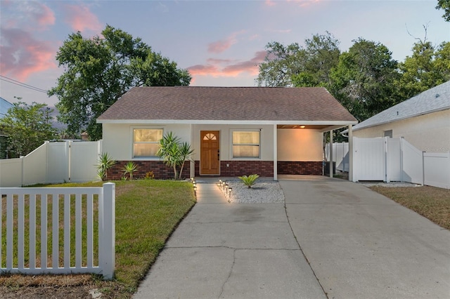 439 E Boyer St, Tarpon Springs, FL 34689 - bungalow-style house with brick siding, a gate, and a lawn