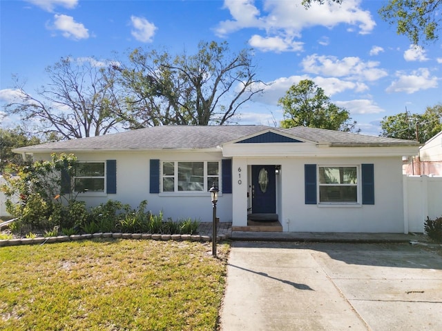 610 N Woodlynne Ave, Tampa, FL 33609 - single story home featuring a shingled roof, driveway, stucco siding, and fence