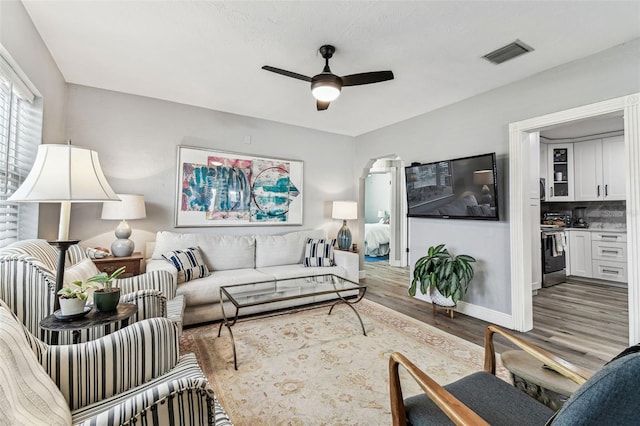 610 N Woodlynne Ave, Tampa, FL 33609 - living area featuring baseboards, visible vents, wood finished floors, and ceiling fan