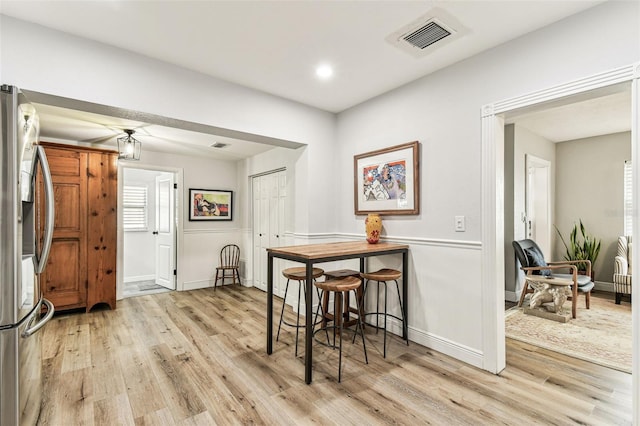 610 N Woodlynne Ave, Tampa, FL 33609 - dining room with baseboards, visible vents, and light wood-style floors