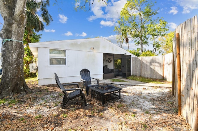 610 N Woodlynne Ave, Tampa, FL 33609 - rear view of property featuring a fenced backyard and a sunroom