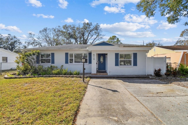 610 N Woodlynne Ave, Tampa, FL 33609 - ranch-style house featuring driveway, stucco siding, fence, and a front lawn