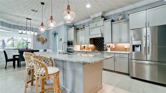 16612 5th Ave E, Bradenton, FL 34212 - kitchen with appliances with stainless steel finishes, backsplash, arched walkways, ornamental molding, and light stone countertops