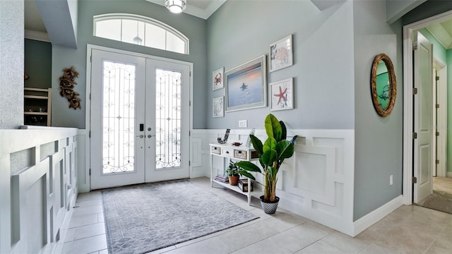 16612 5th Ave E, Bradenton, FL 34212 - foyer entrance featuring french doors, tile patterned flooring, wainscoting, and a towering ceiling