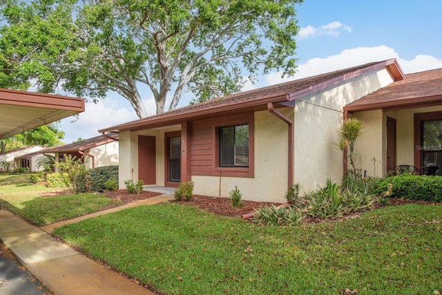 view of front of property with stucco siding and a front yard