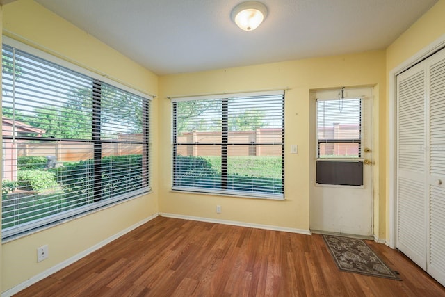 empty room with baseboards and wood finished floors