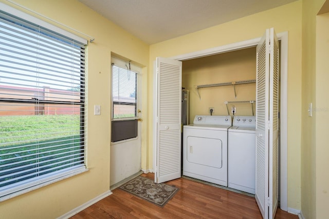 laundry room featuring independent washer and dryer, wood finished floors, laundry area, and baseboards