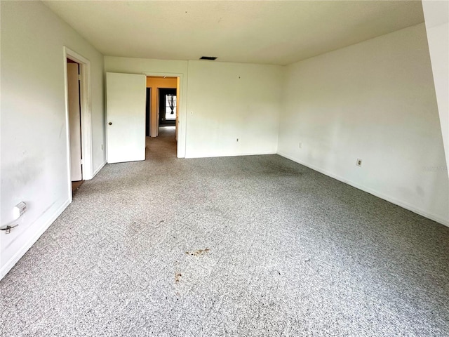 spare room with baseboards and visible vents