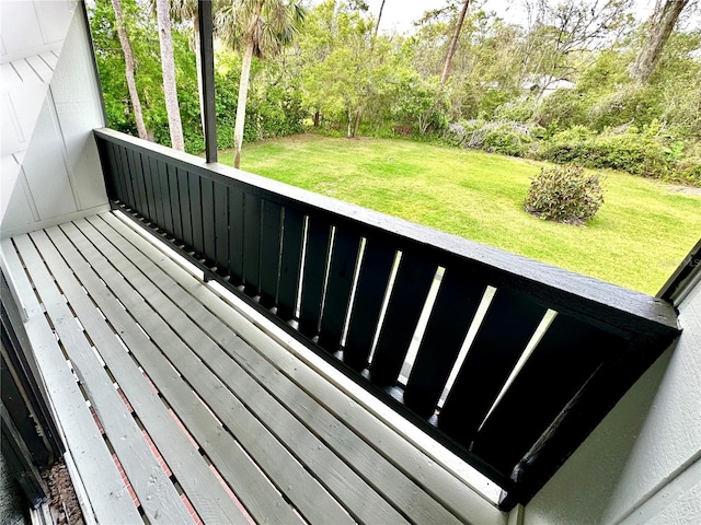 wooden deck featuring a yard