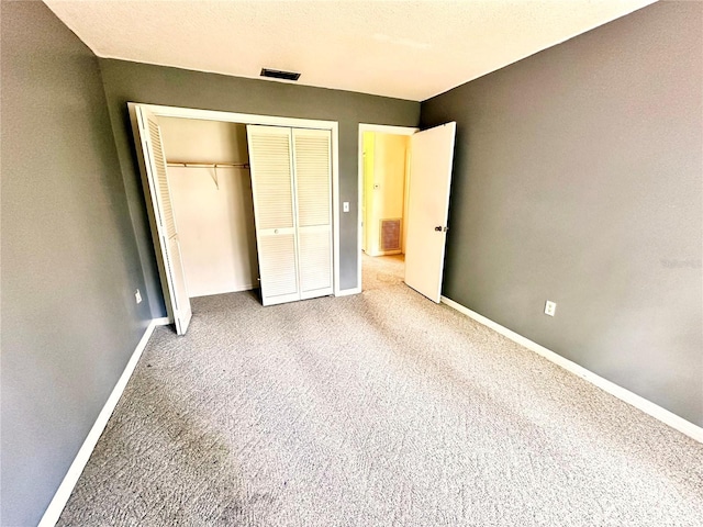 unfurnished bedroom featuring carpet, visible vents, and baseboards