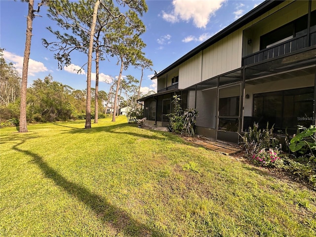 view of yard with a balcony