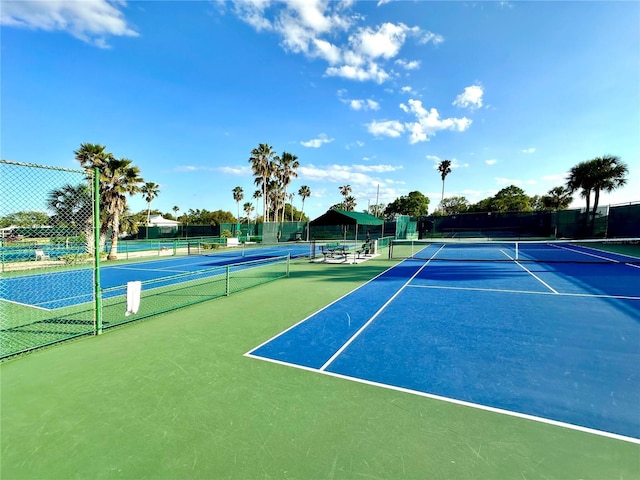 view of tennis court with fence