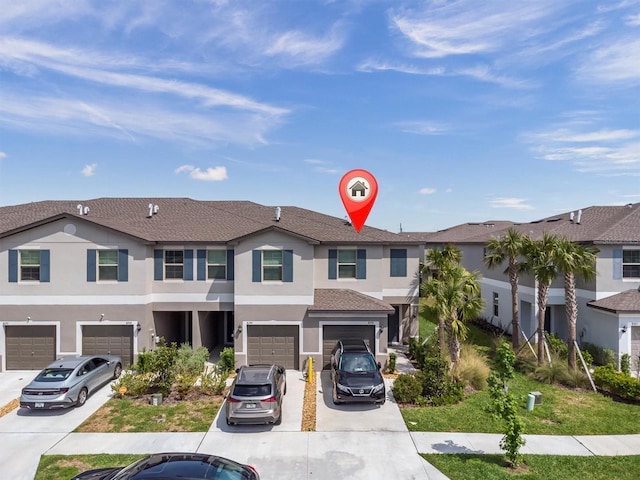 8299 Crescent Oaks Dr, New Port Richey, FL 34655 - view of property with driveway, an attached garage, and stucco siding