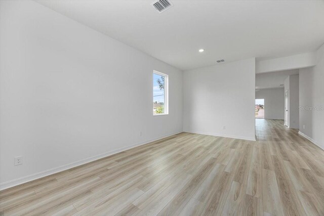 385 Begonia Ct, Poinciana, FL 34759 - empty room with plenty of natural light, light wood-style floors, baseboards, and recessed lighting
