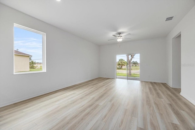 385 Begonia Ct, Poinciana, FL 34759 - spare room with a ceiling fan, light wood finished floors, and baseboards