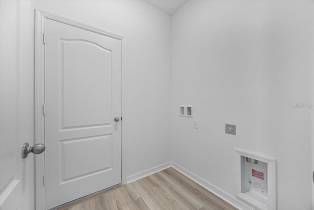 385 Begonia Ct, Poinciana, FL 34759 - washroom with electric dryer hookup, washer hookup, light wood-style flooring, and baseboards