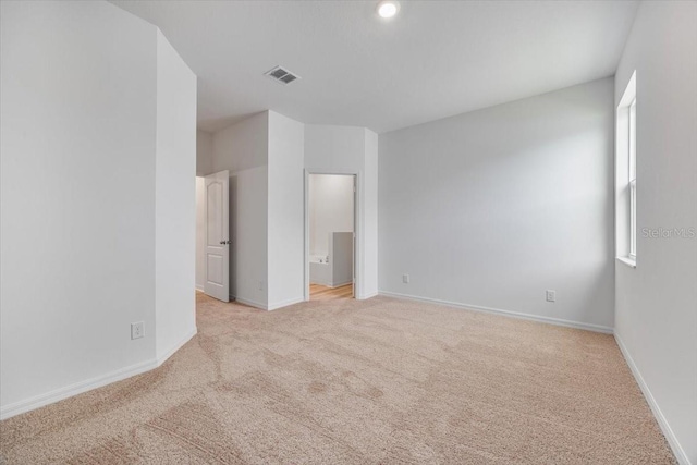 385 Begonia Ct, Poinciana, FL 34759 - unfurnished bedroom featuring light carpet, baseboards, and ensuite bath