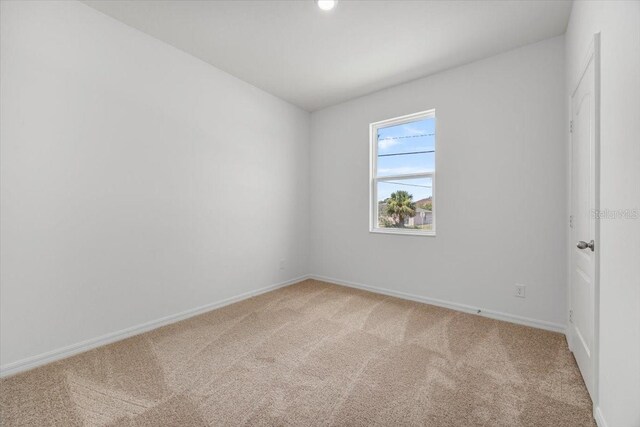 385 Begonia Ct, Poinciana, FL 34759 - spare room with light colored carpet and baseboards