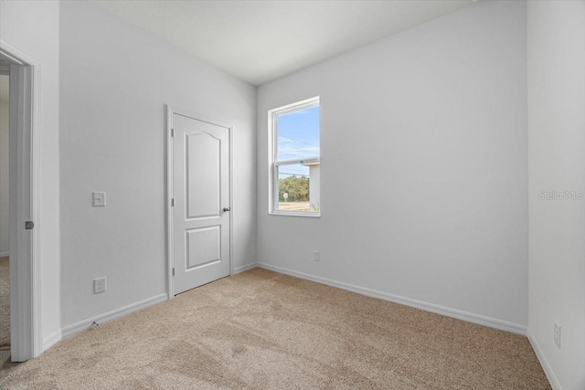 385 Begonia Ct, Poinciana, FL 34759 - unfurnished bedroom with light carpet and baseboards