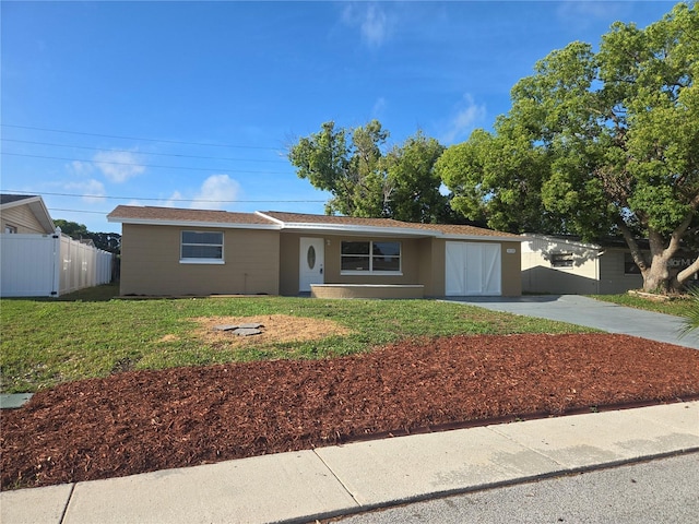 5130 Tilson Dr, New Port Richey, FL 34652 - ranch-style home with driveway, fence, and a front lawn
