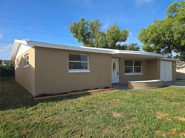 5130 Tilson Dr, New Port Richey, FL 34652 - view of front of property with concrete block siding and a front yard