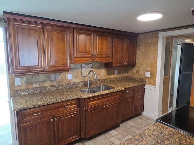 5130 Tilson Dr, New Port Richey, FL 34652 - kitchen featuring a sink, freestanding refrigerator, dark stone countertops, range with electric cooktop, and stone finish floor